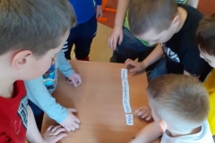 Grupa chłopców układających zdanie z zebranych wyrazów