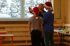 Mężczyzna z dwoma uczniami prezentuje doświadczenie